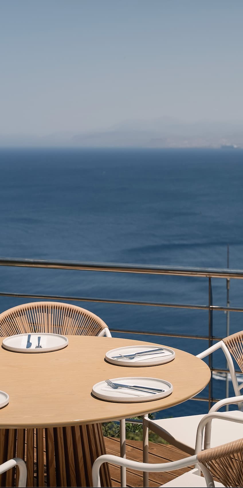 A laid table at Thyrea looking out over the sea and the hills of Crete