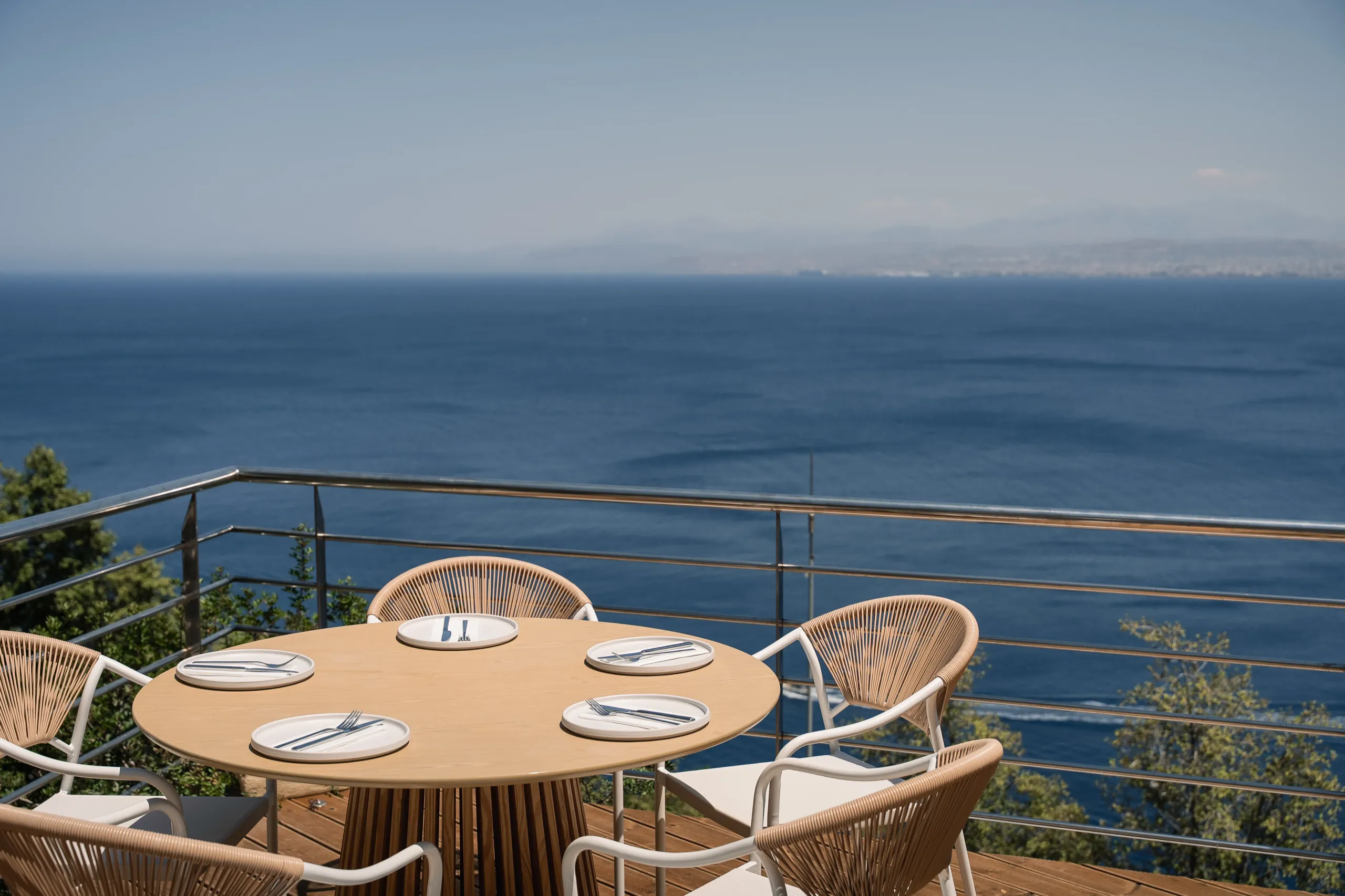 A laid table at Thyrea looking out over the sea and the hills of Crete